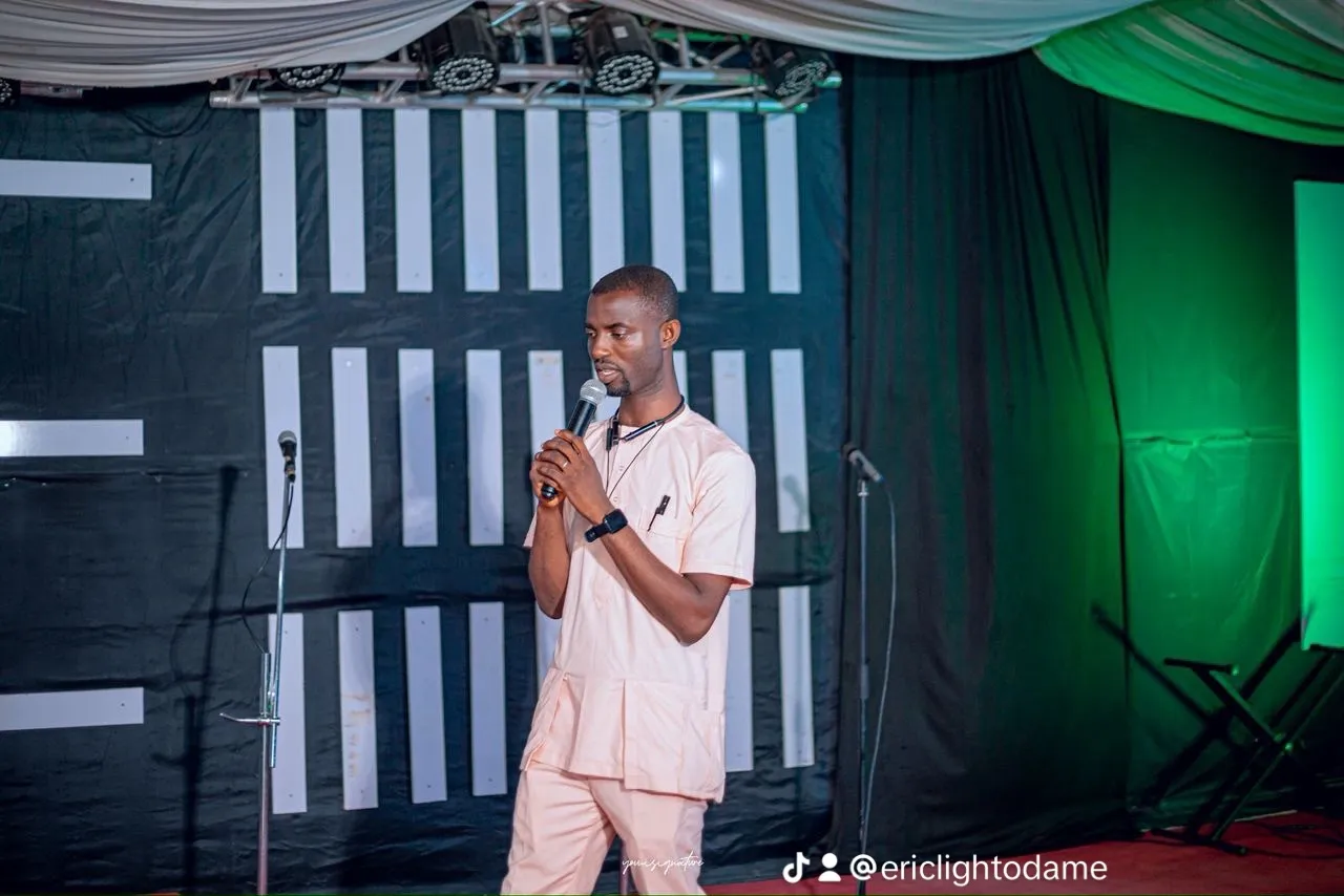 Eric Light Odame speaking into a microphone on stage